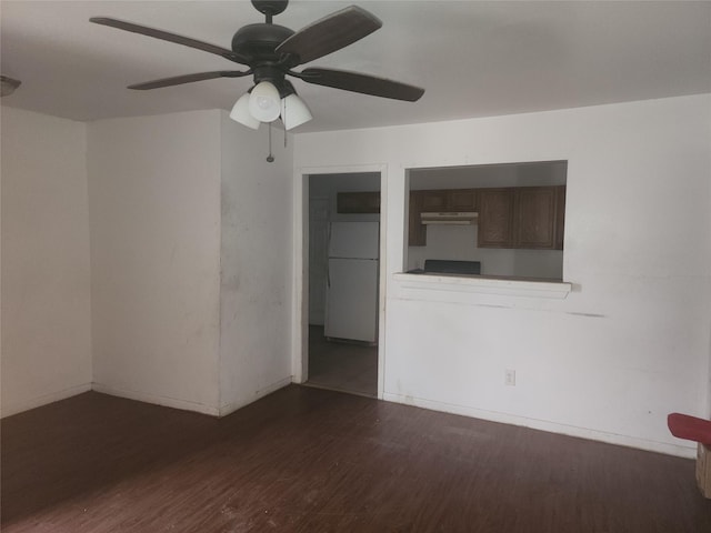 unfurnished room with ceiling fan and dark hardwood / wood-style floors