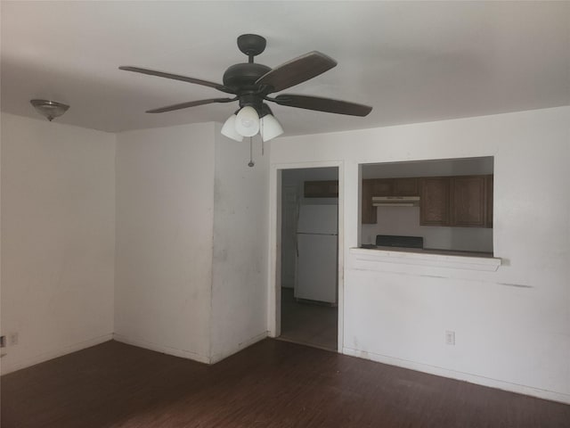 spare room with dark wood-type flooring and ceiling fan