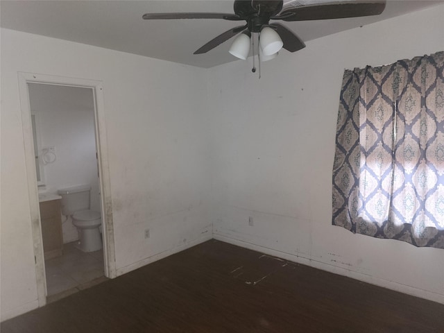 spare room with ceiling fan and dark hardwood / wood-style floors