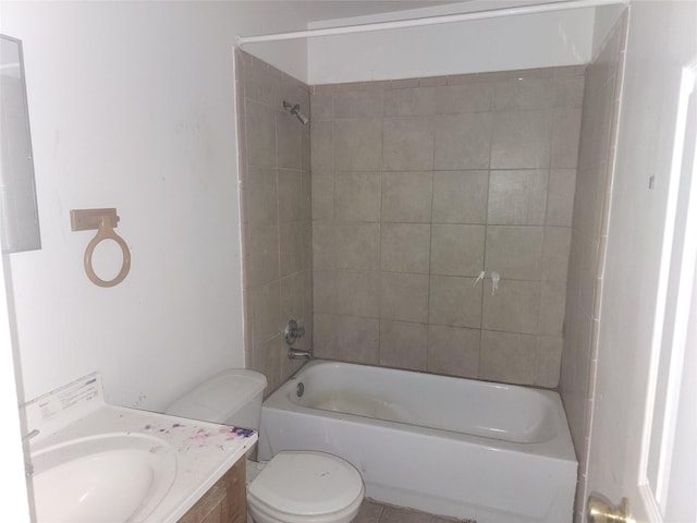 full bathroom with vanity, toilet, and tiled shower / bath combo