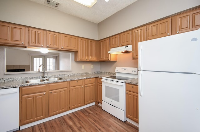 kitchen featuring a textured ceiling, sink, dark hardwood / wood-style floors, and white appliances