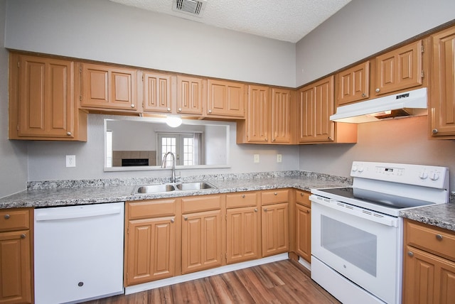 kitchen with white appliances, a textured ceiling, sink, dark hardwood / wood-style floors, and stone counters