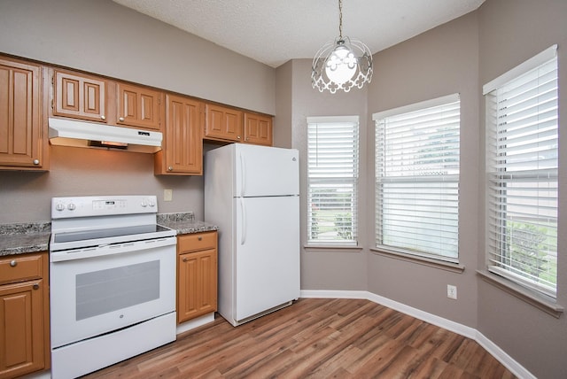 kitchen with white appliances, stone countertops, hanging light fixtures, a chandelier, and light hardwood / wood-style flooring