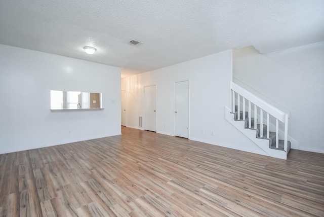 interior space featuring hardwood / wood-style flooring and a textured ceiling