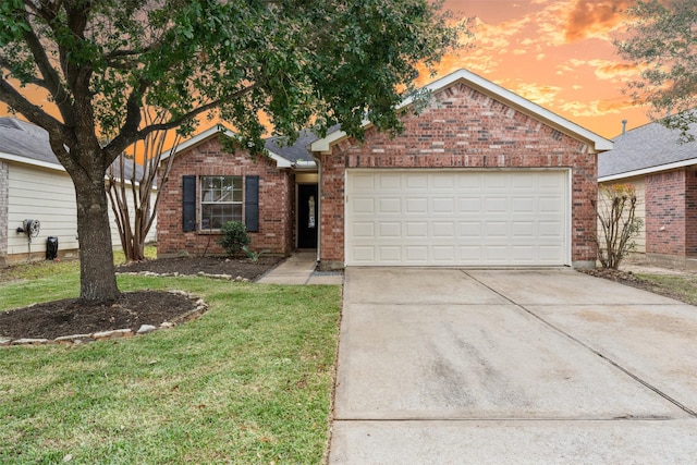 view of front of property featuring a lawn and a garage