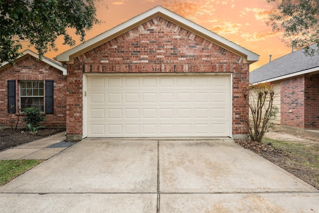 view of garage at dusk