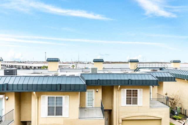 view of property with a garage and central AC unit