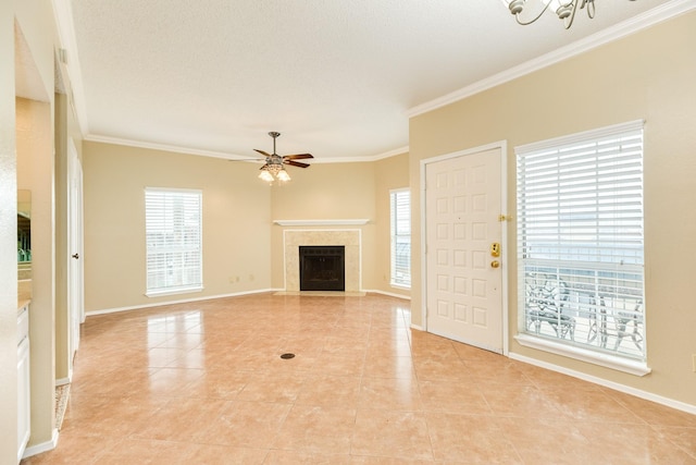 unfurnished living room with ceiling fan with notable chandelier, a textured ceiling, light tile patterned floors, and crown molding