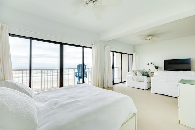 bedroom with ceiling fan, multiple windows, access to outside, and a water view