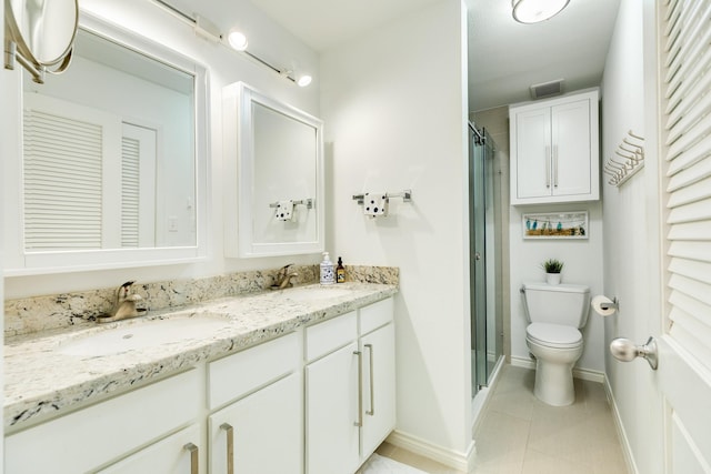 bathroom featuring toilet, an enclosed shower, tile patterned floors, and vanity