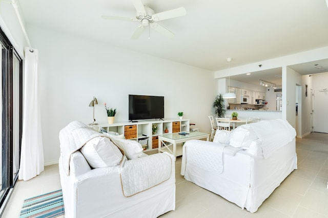 tiled living room featuring ceiling fan