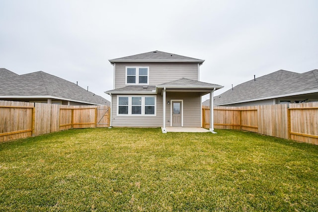 back of property with a patio area and a yard