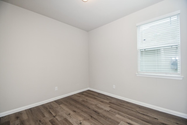 empty room featuring dark wood-type flooring