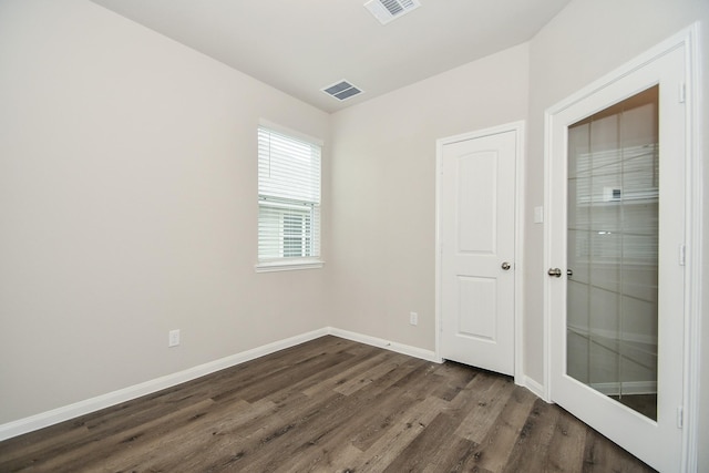 empty room with dark wood-type flooring