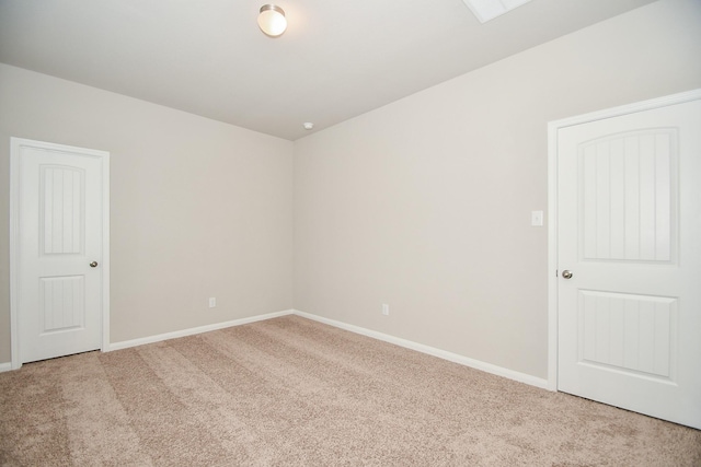 unfurnished room featuring light colored carpet