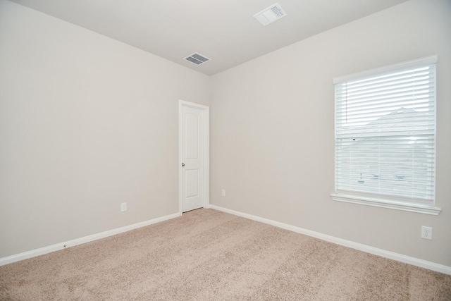 empty room featuring light colored carpet