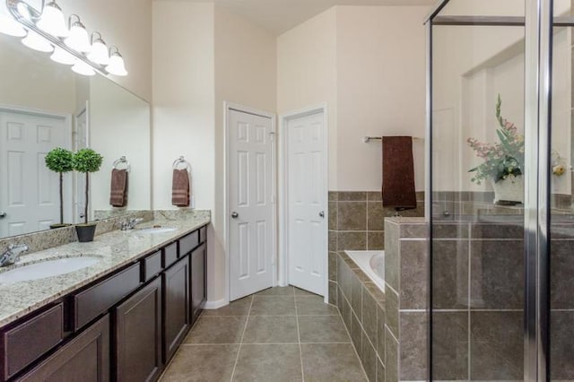 bathroom featuring shower with separate bathtub, vanity, and tile patterned flooring