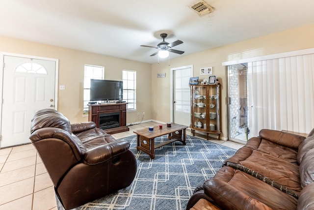 living room featuring ceiling fan and tile patterned floors