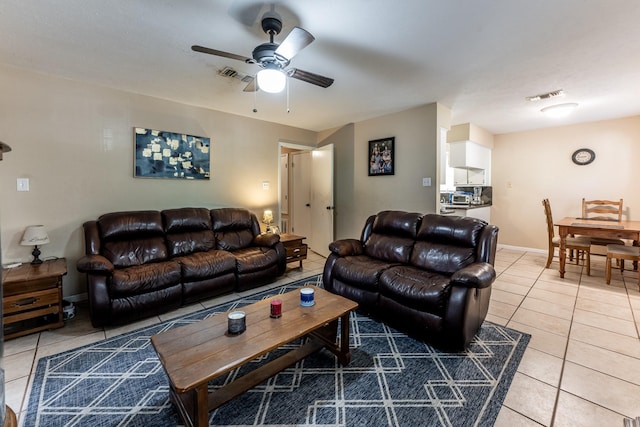 tiled living room with ceiling fan