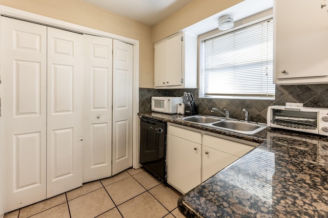 kitchen with light tile patterned floors, white cabinetry, tasteful backsplash, dishwasher, and sink