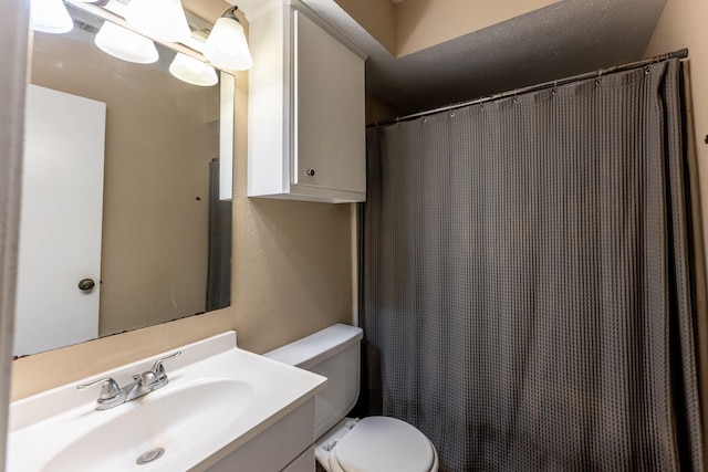 bathroom featuring toilet and vanity