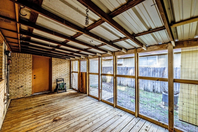 unfurnished sunroom with vaulted ceiling