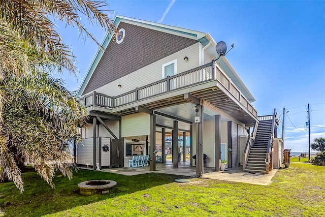 rear view of property with an outdoor bar, an outdoor fire pit, a yard, and a patio