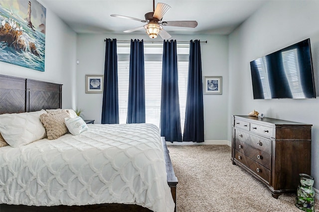 carpeted bedroom featuring ceiling fan and multiple windows