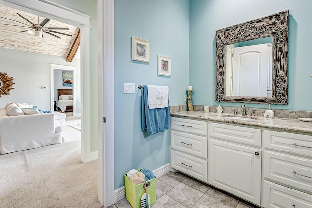 bathroom with ceiling fan, vaulted ceiling with beams, tile patterned floors, and vanity