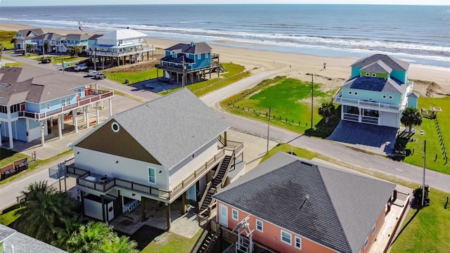 birds eye view of property with a water view and a view of the beach