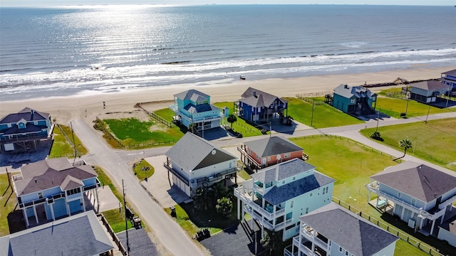 bird's eye view with a water view and a beach view