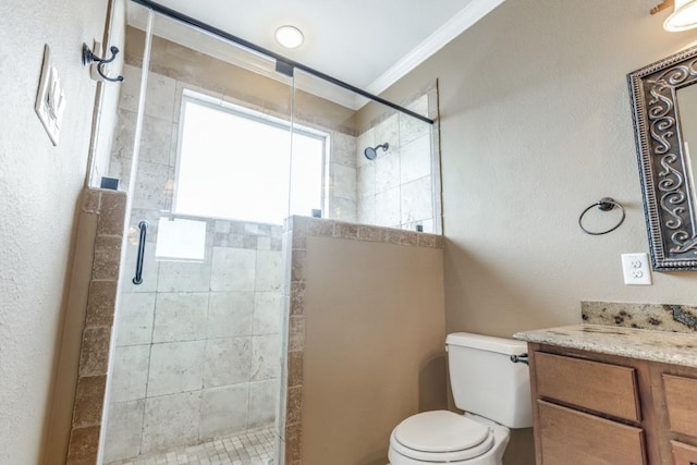 bathroom with toilet, ornamental molding, walk in shower, and vanity