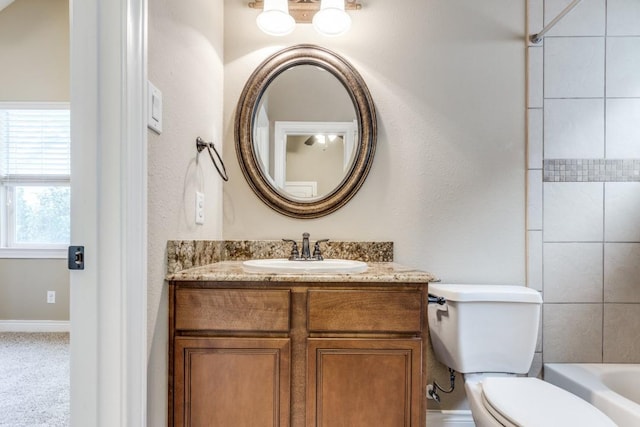 bathroom featuring toilet and vanity