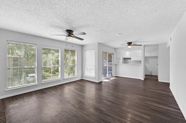 unfurnished living room featuring ceiling fan, dark hardwood / wood-style flooring, and a textured ceiling