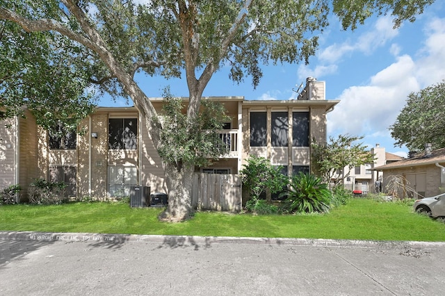 view of front of home featuring a front lawn and a sunroom