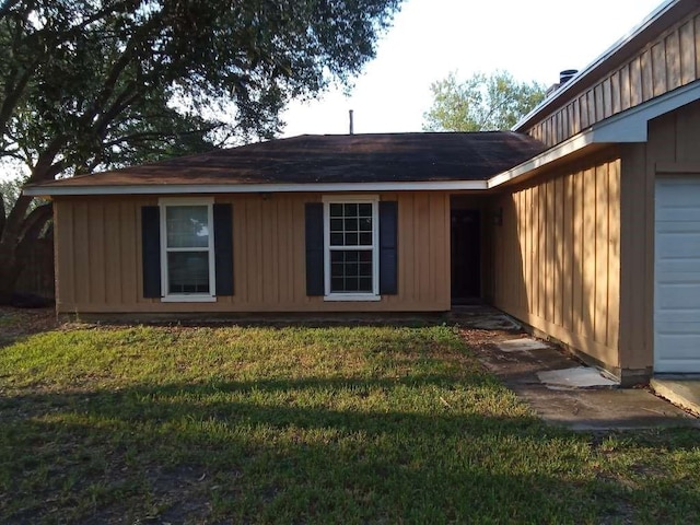 exterior space with a yard and a garage