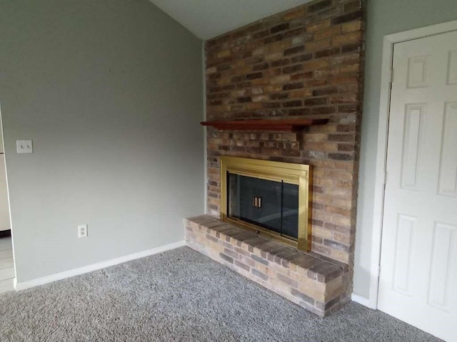 unfurnished living room featuring a brick fireplace and carpet