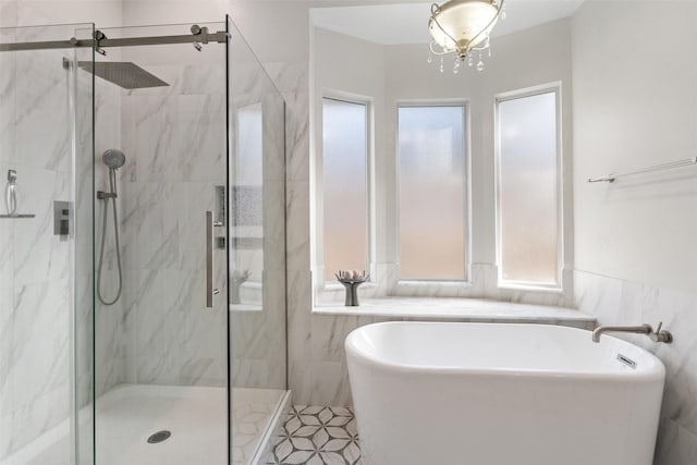 bathroom featuring shower with separate bathtub and plenty of natural light