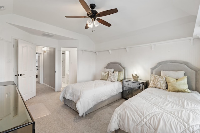 bedroom with ceiling fan, light colored carpet, ensuite bath, and vaulted ceiling