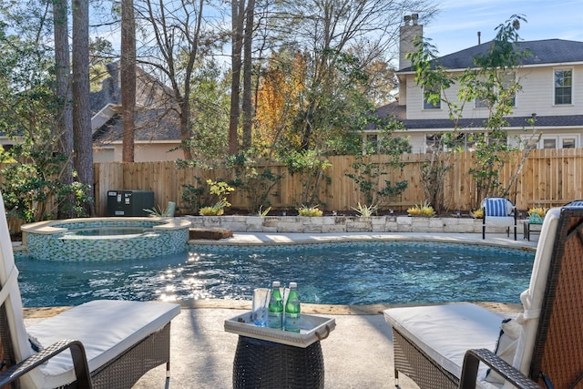 view of swimming pool with an in ground hot tub