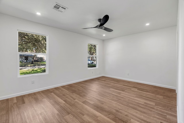 spare room with light wood-type flooring and ceiling fan