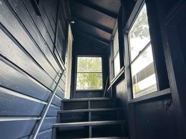 stairway featuring vaulted ceiling