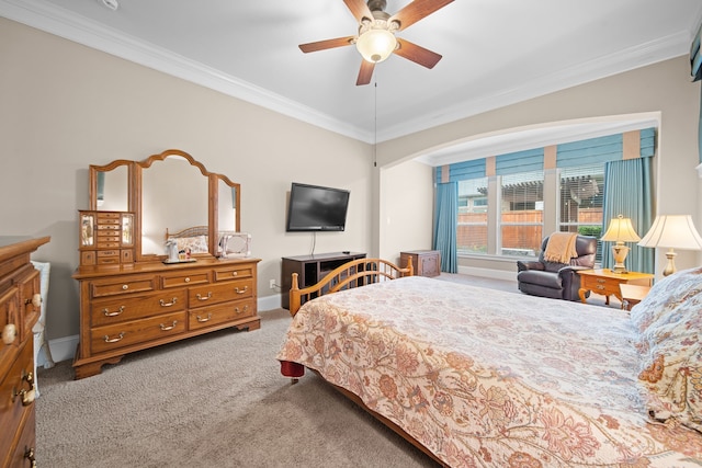 bedroom featuring crown molding, ceiling fan, and carpet