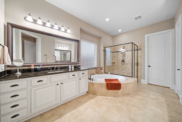 bathroom featuring tile patterned floors, vanity, and shower with separate bathtub