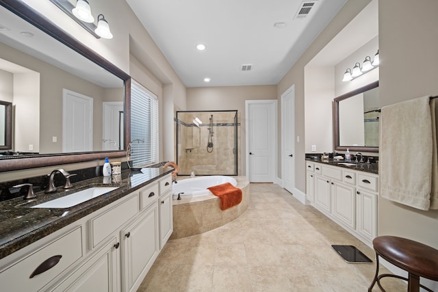 bathroom featuring vanity and separate shower and tub