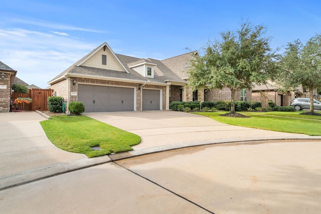 view of front of home featuring a garage, a front yard, fence, brick siding, and driveway