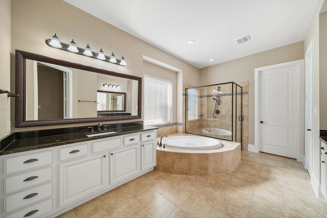 bathroom with vanity, tile patterned flooring, a shower stall, visible vents, and a bath