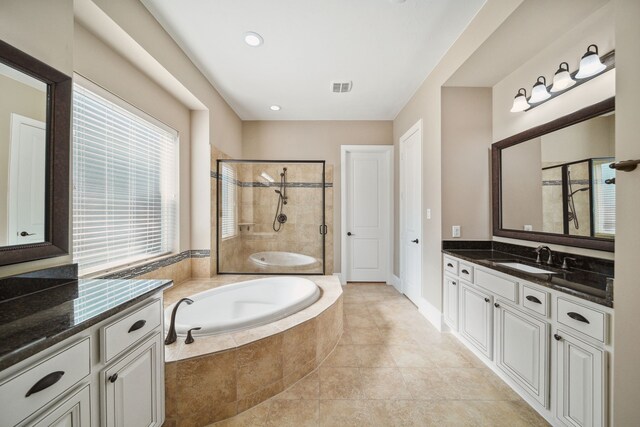 full bathroom with a shower stall, a bath, vanity, visible vents, and tile patterned floors