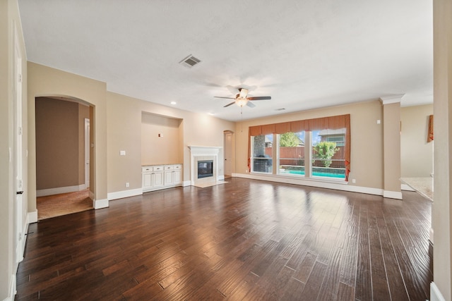 unfurnished living room with a fireplace with flush hearth, ceiling fan, wood-type flooring, and baseboards