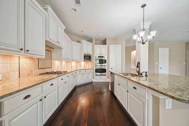 kitchen with visible vents, white cabinets, a sink, appliances with stainless steel finishes, and dark wood finished floors